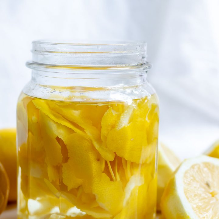 lemon peels and clear vinegar in glass jar