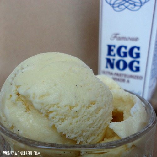 scoop of ice cream in clear glass bowl with eggnog carton in the background