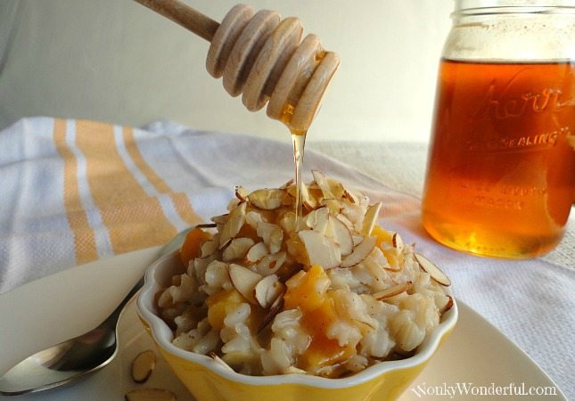 honey drizzling over rice pudding, honey jar in background