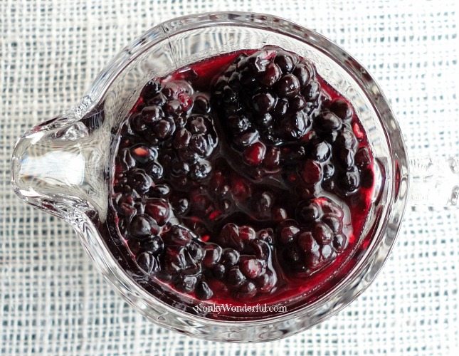 chunky blackberry syrup in clear glass measuring cup
