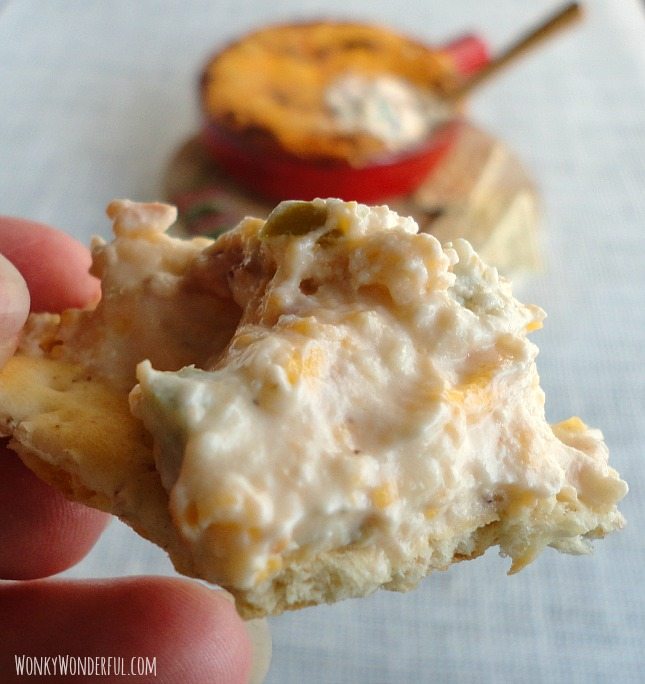 hand holding Jalapeno Popper Dip on a cracker