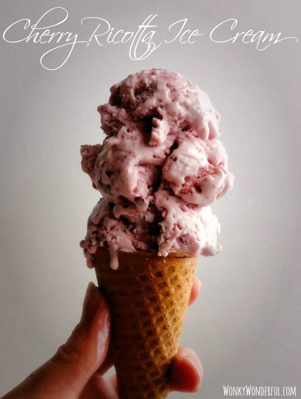 hand holding cone filled with Cherry Ricotta Ice Cream, photo text: cherry ricotta ice cream