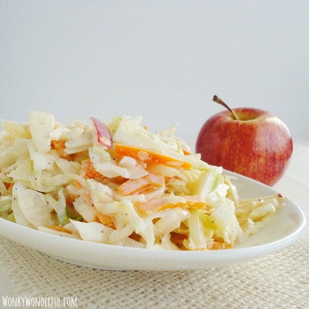 Apple Cabbage Coleslaw in white serving dish with apple on the side