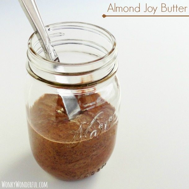 brown nut butter in glass jar with silver knife