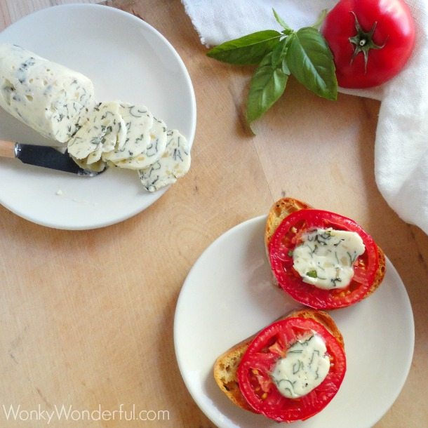 above view of two white plates, one with tomato crostini and the other with herb butter