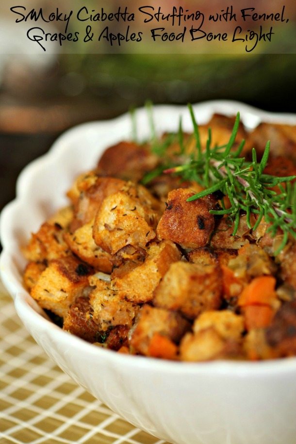 crusty chunky bread cubes topped with fresh rosemary in white bowl
