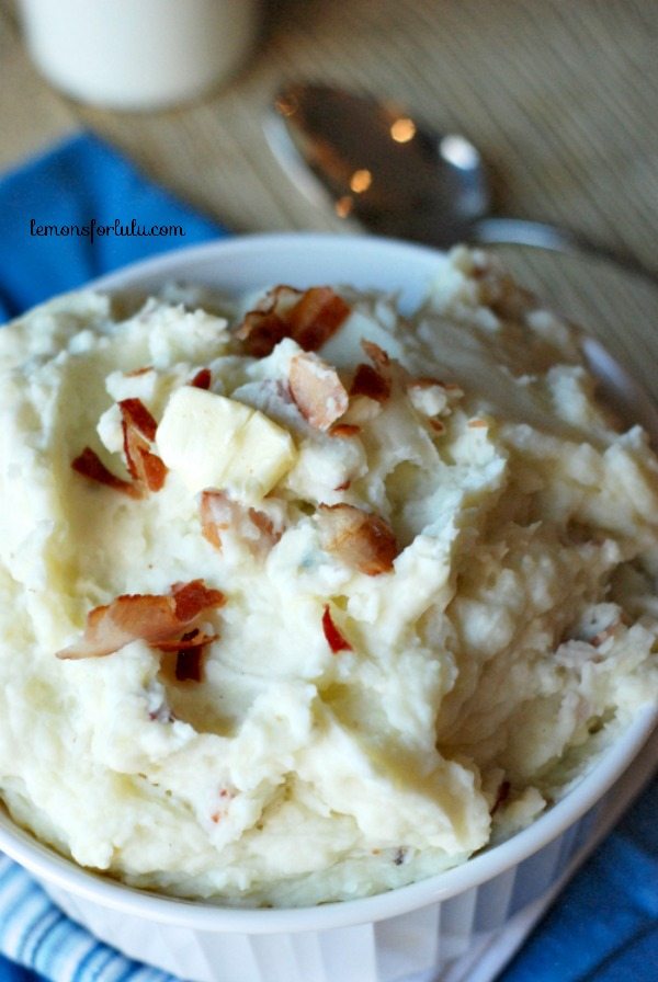 mashed potatoes topped with bacon and butter in white dish