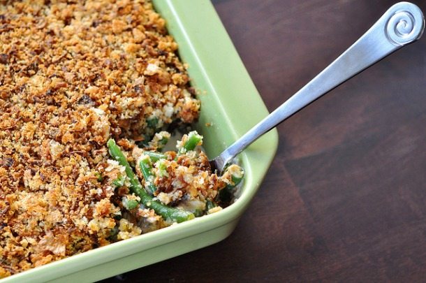 crusty topped green beans in light green casserole dish
