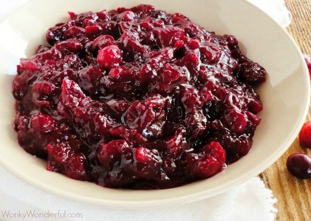 chunky dark red cranberry sauce in beige bowl