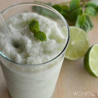 clear glass filled with creamy smoothie topped with mint leaf