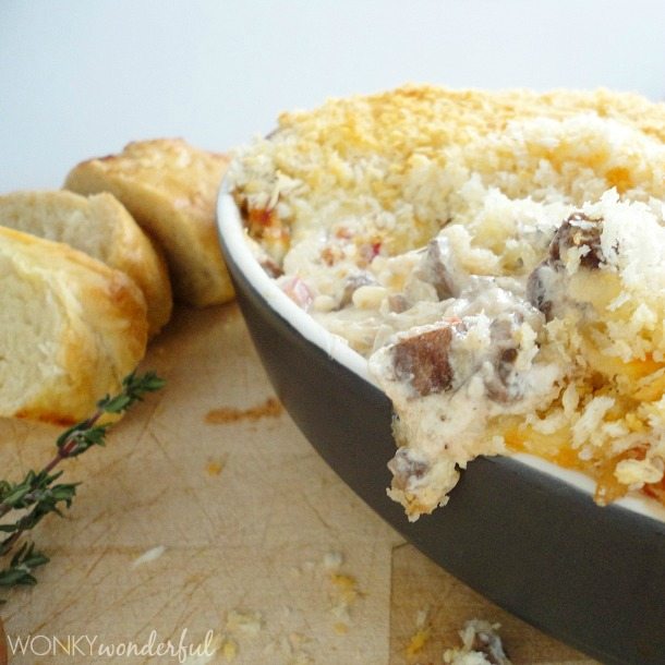 side photo of melty cheesy dip in black serving dish