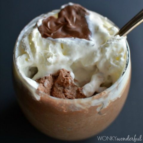 chocolate mouse, whipped cream and chocolate heart in clear glass