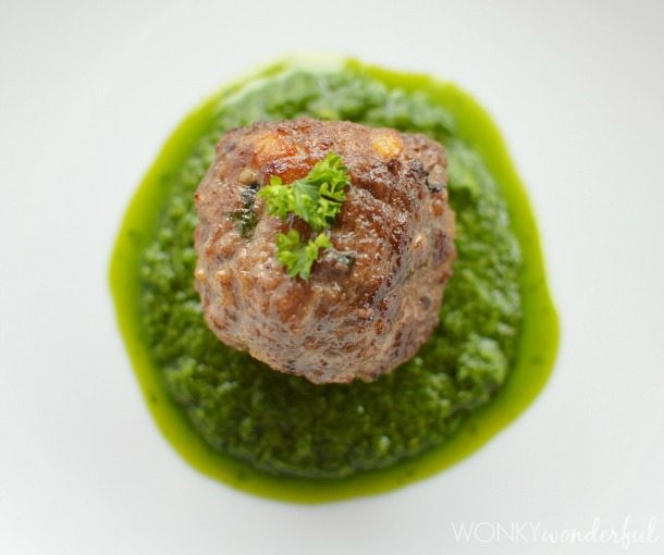 above view of meatball on green sauce