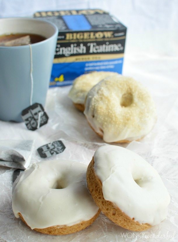white glaze donuts, blue tea mug and box of tea in background