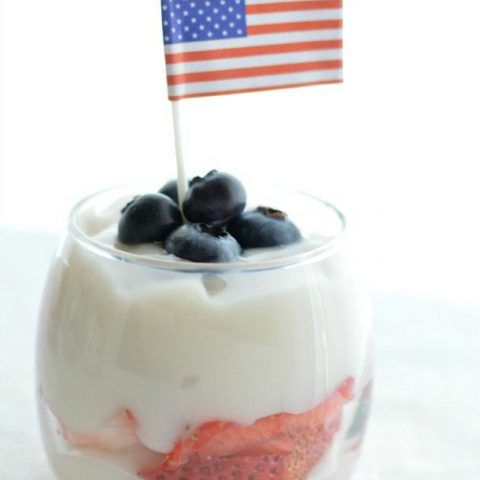 white pudding topped with blueberries and a mini American flag