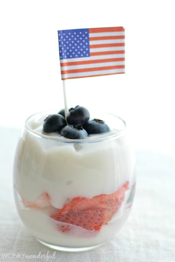 white pudding topped with blueberries and a mini American flag