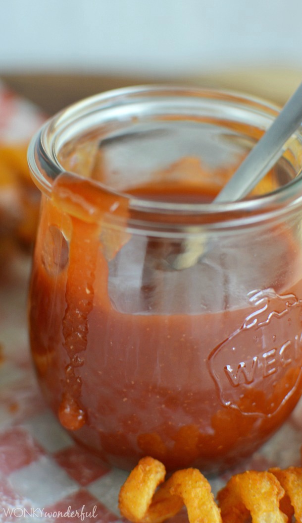 Get your Arby's Roast Beef fix without leaving home! With this Copycat Arby's Sauce Recipe you can make your own version of the fast food favorite! red sauce in clear glass jar next to curly fry
