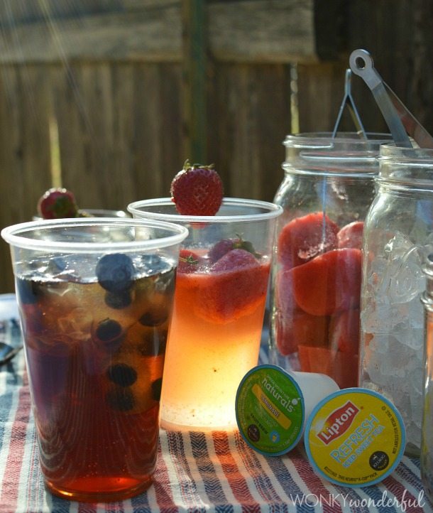 clear cups filled with lemonade, tea and fruit next to Keurig pods