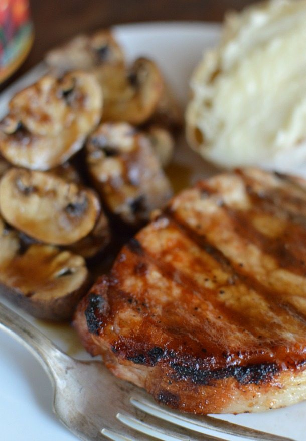 Grill Season Is Here! Homemade Barbecue Sauce is a great way to get creative with your grill recipes. This unique Sweet and Sour Barbecue Sauce Recipe requires only 4 ingredients! grilled bbq pork chop and mushrooms on white plate