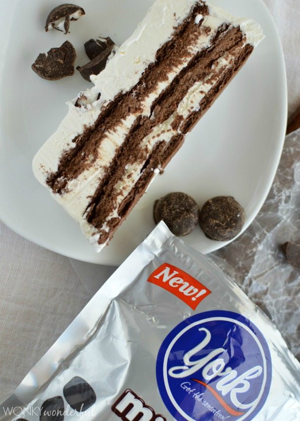 slice of brown and white layered cake next to package or York minis