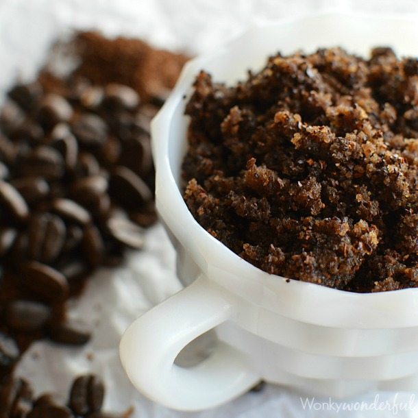 dark brown scrub in white dish next to coffee beans