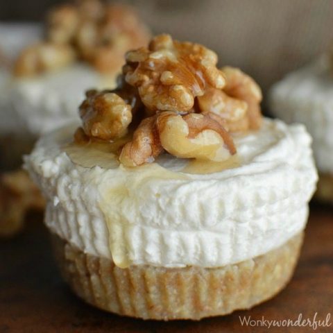 tan and white layered mini cheesecake topped with walnuts and honey