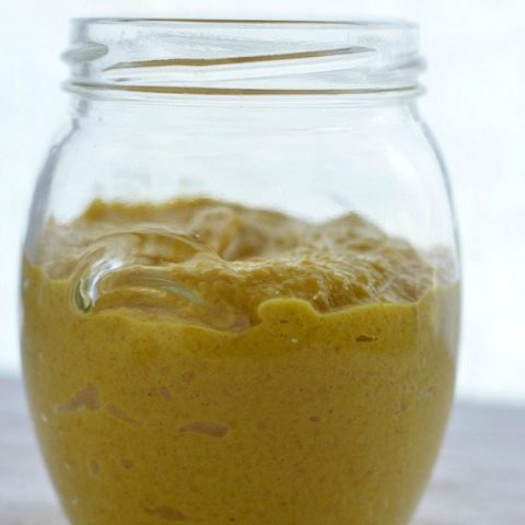 clear jar with yellow mustard inside