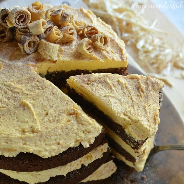 brown and yellow layer cake topped with curly cookie pieces