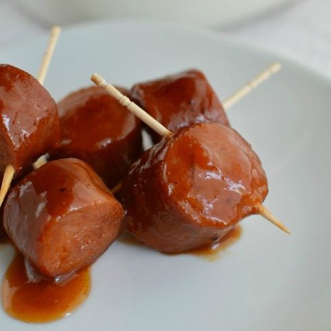 bbq sausage bites with toothpicks served on white plate