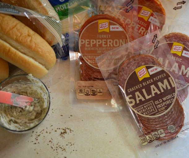 Hot Italian Sandwiches baked in the oven. Meaty Cheesy Sub Sandwiches, great for feeding a large crowd! #easydinner #gamedayfood #sandwiches ingredients for hot italian sandwiches, salami, pepperoni, rolls