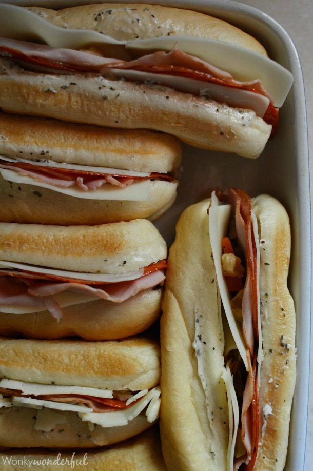 Hot Italian Sandwiches baked in the oven. Meaty Cheesy Sub Sandwiches, great for feeding a large crowd! #easydinner #gamedayfood #sandwiches sandwiches prepared and about to go into oven