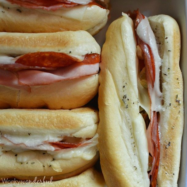 Hot Italian Sandwiches baked in the oven. Meaty Cheesy Sub Sandwiches, great for feeding a large crowd!