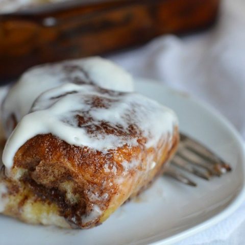 cinnamon roll topped with cream cheese glaze