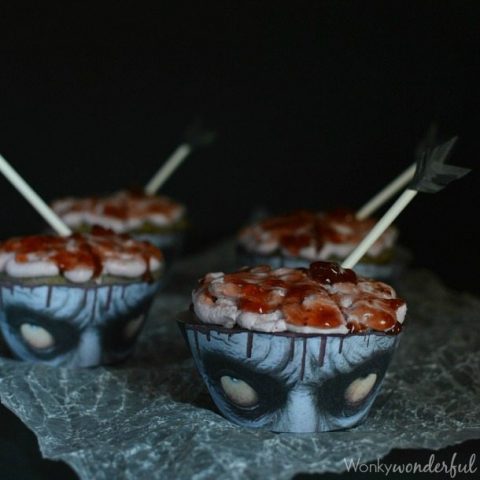 cupcakes with zombie face paper liners