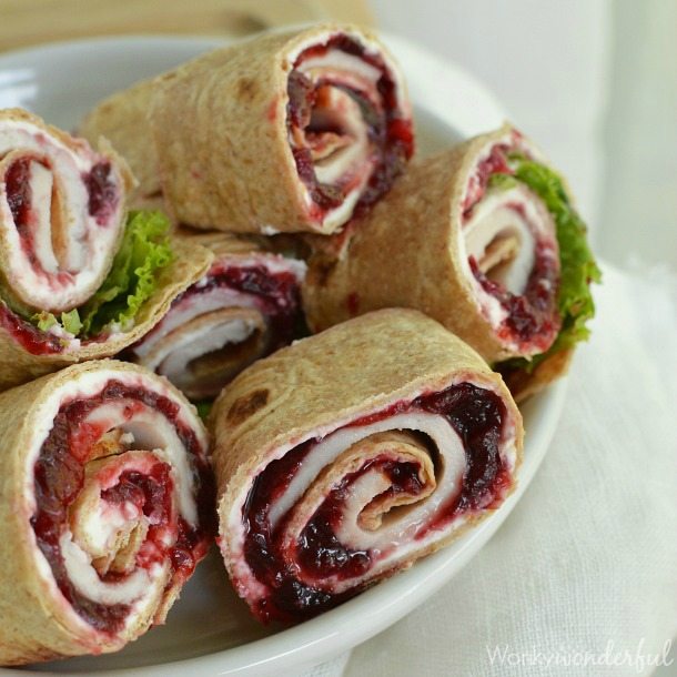 tortillas filled with turkey and cranberry sauce then sliced on white plate