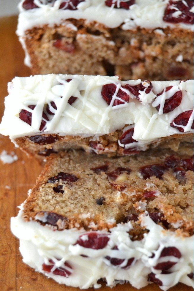 light brown bread slices topped with white glaze and dark red cranberries