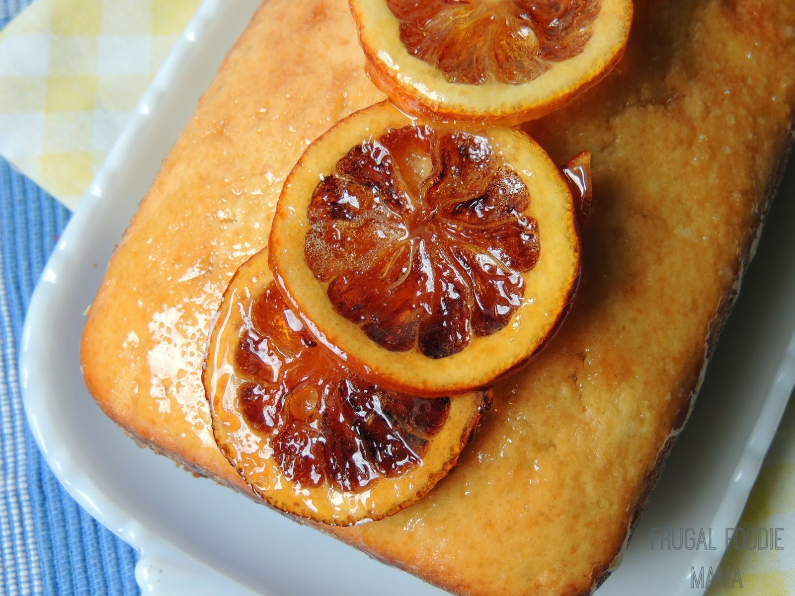 light colored loaf topped with shiny glazed sliced lemons