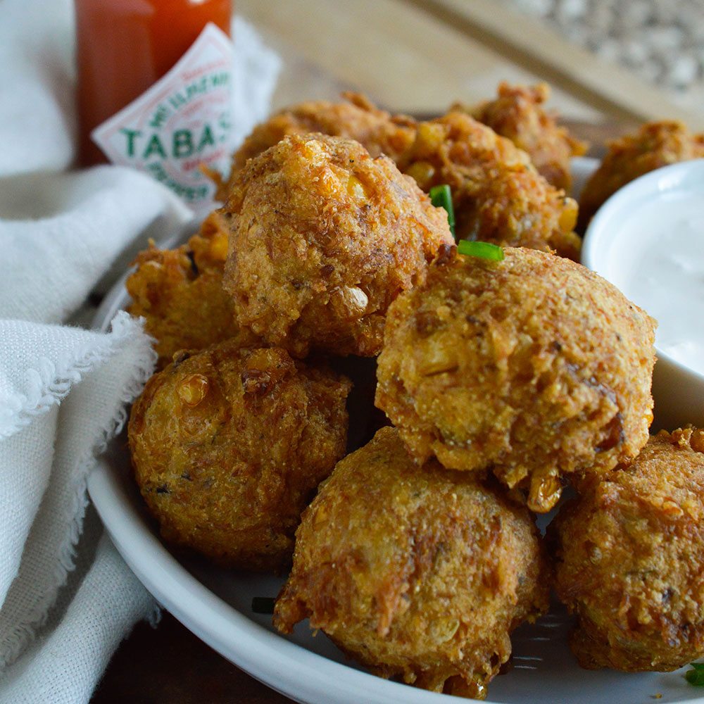 Crab Corn Fritters Recipe - These deep fried fritters are full of crab, corn and cajun spices. Serve with creamy Tabasco dipping sauce.