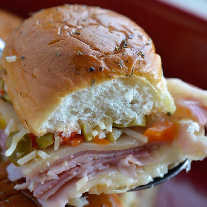 Muffalata Oven Baked Sandwiches - This Italian Sandwich is loaded with meat, cheese and olive salad. A New Orleans favorite, baked in the oven and perfect for feeding a crowd! Dinner Recipe