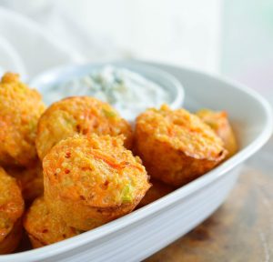 Quinoa Buffalo Bites have all the flavor of buffalo wings but are low fat and low calorie. This gluten free appetizer recipe is perfect for game day or parties! Baked quinoa bites with blue cheese Greek yogurt dipping sauce.