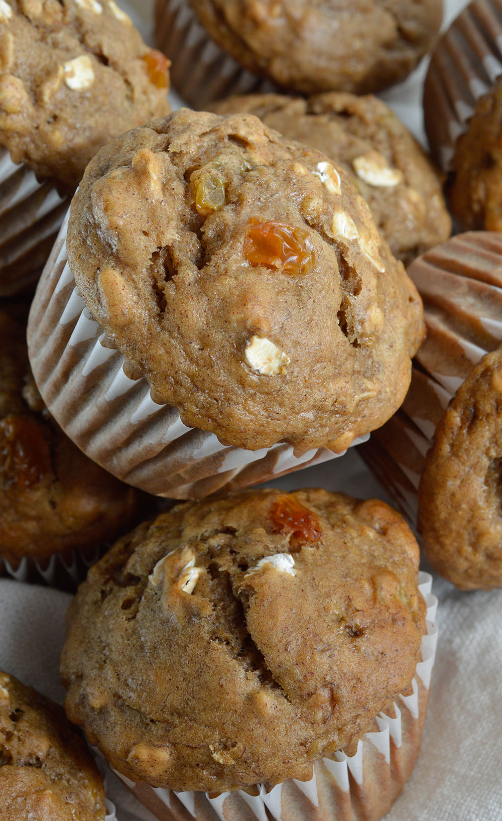 stack of banana bread breakfast muffins with white muffin liners