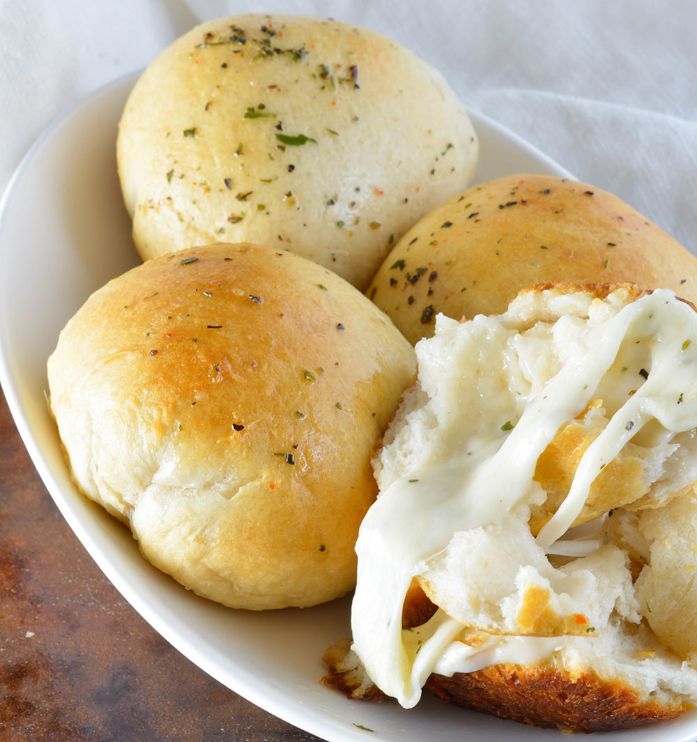 2 Ingredient Cheese Biscuits Recipe - The cheesy rolls are made easy with store bought refrigerated biscuits and herb marinated mozzarella cheese! A quick and easy side dish or appetizer!