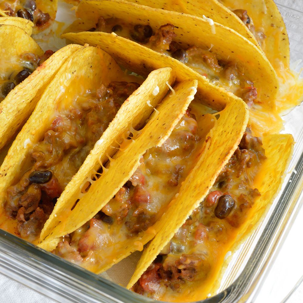 Oven Baked Tacos are perfect for feeding a crowd! This quick and easy taco recipe is full of flavor and melty cheese! Also a great weeknight dinner meal.