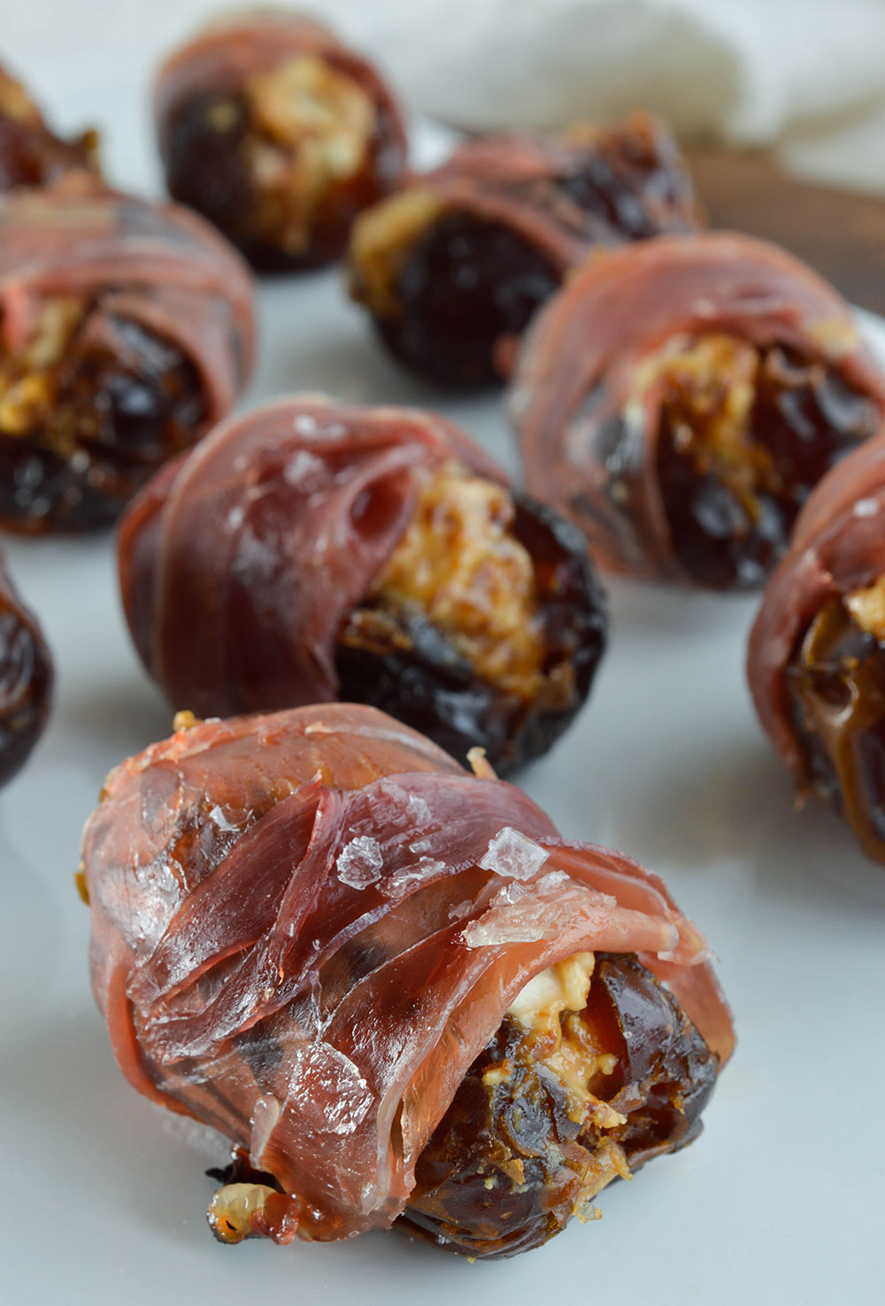 Prosciutto Wrapped Dates Stuffed with Goat Cheese and Fig Butter make the perfect hors d'oeuvres. Serve with a drizzle of honey and sprinkle of salt for the ultimate salty sweet appetizer recipe!