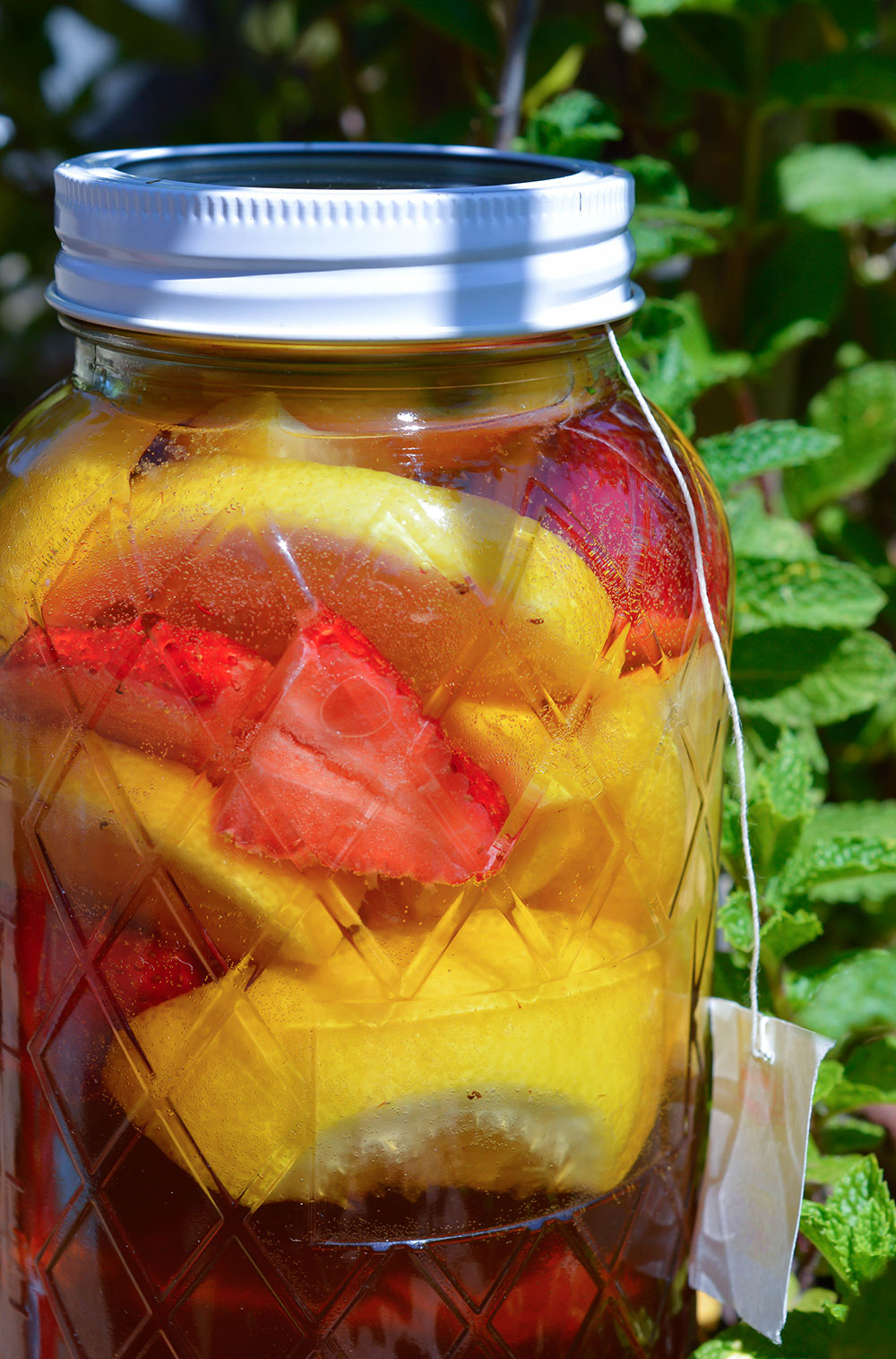 Strawberry Lemonade Sun Tea Recipe - This is the perfect summertime beverage. A naturally fruit flavored tea with no added sugar! Tastes like homemade Snapple!