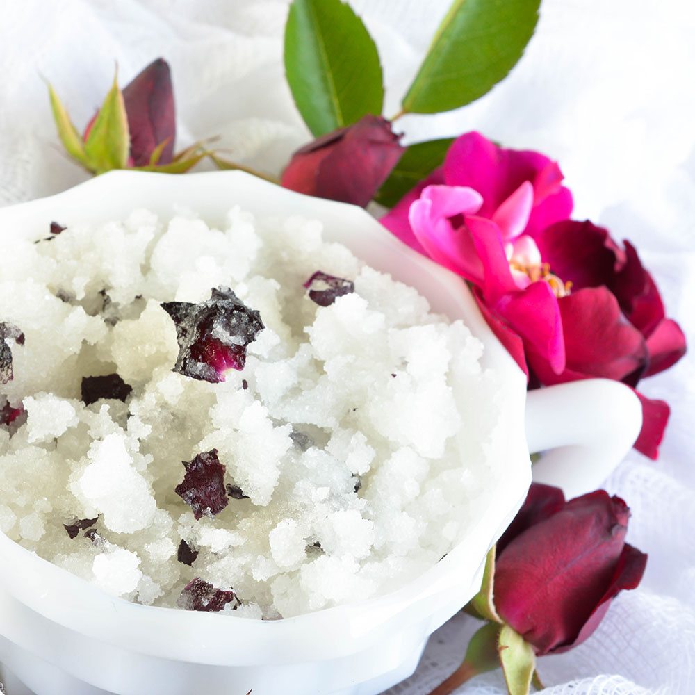 Rose Scented DIY Body Scrub Recipe - This homemade sugar scrub has a delicate rose smell and real rose petals. The perfect gift for Mom. Or give the wife a luxurious spa day at home!