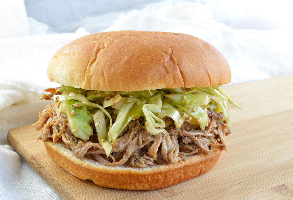 Chinese Five Spice Slow Cooker Pulled Pork Recipe - These Asian Spiced Pulled Pork Sandwiches are topped with marinated cabbage slaw, sesame seeds and served on a soft bun. These are made with pork tenderloin and great for a weeknight crockpot dinner!