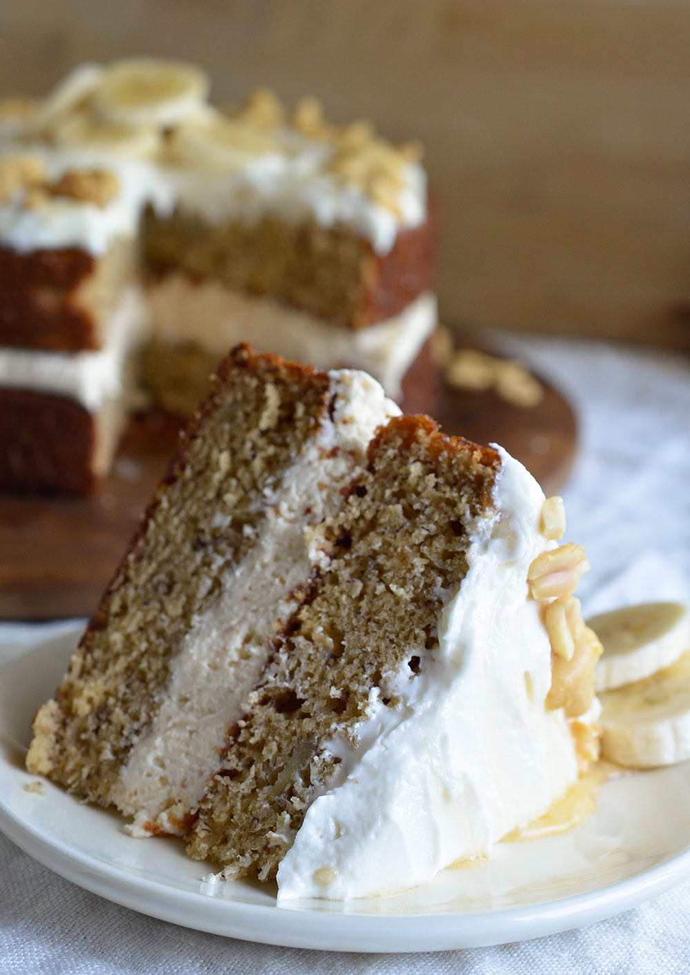 Banana Layer Cake with Peanut Butter and Honey Frosting. This fun and easy naked layer cake will take you back to your childhood! The perfect blend of peanut butter, honey and banana in one impressive dessert recipe!
