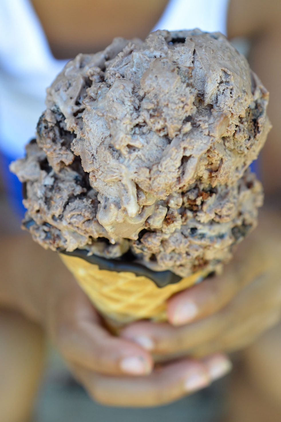 Extreme Chocolate Ice Cream is a must make recipe. This No Churn Ice Cream is packed with Chocolate Chunks and Brownies! Inspired by my favorite Dairy Queen Blizzard flavor. Death By Chocolate never tasted so good! #nochurnicecream #chooclateicecream hands holding ice cream
