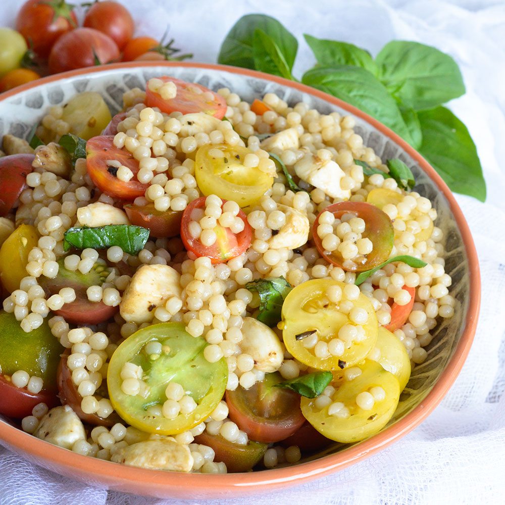 Caprese Couscous Salad Recipe - This fresh and easy side dish is full of flavor! Fresh tomato, mozzarella and basil with couscous and balsamic dressing.